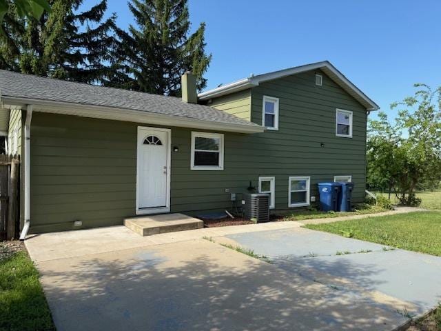 3018 20th St, North Chicago, IL 60064 - split level home with a patio and a chimney