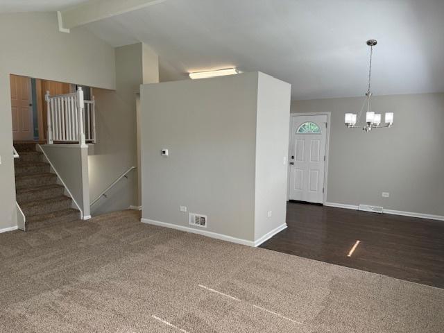 3018 20th St, North Chicago, IL 60064 - unfurnished living room with a chandelier, carpet flooring, and stairway