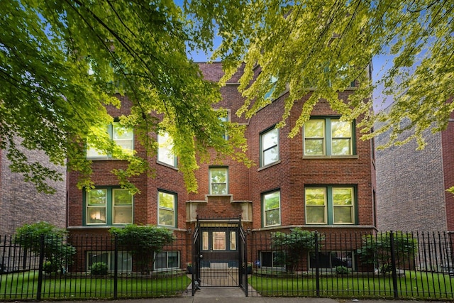 2753 N Spaulding Ave Unit Gs, Chicago, IL 60647 - view of front of house with brick siding and a fenced front yard