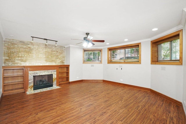 2753 N Spaulding Ave Unit Gs, Chicago, IL 60647 - unfurnished living room featuring rail lighting, healthy amount of natural light, wood finished floors, ornamental molding, and recessed lighting