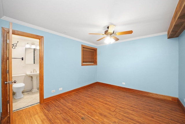 2753 N Spaulding Ave Unit Gs, Chicago, IL 60647 - unfurnished bedroom with wood finished floors, ornamental molding, ceiling fan, and ensuite bathroom