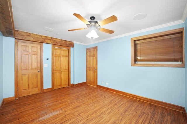 2753 N Spaulding Ave Unit Gs, Chicago, IL 60647 - unfurnished bedroom featuring wood finished floors, ornamental molding, a ceiling fan, and a closet