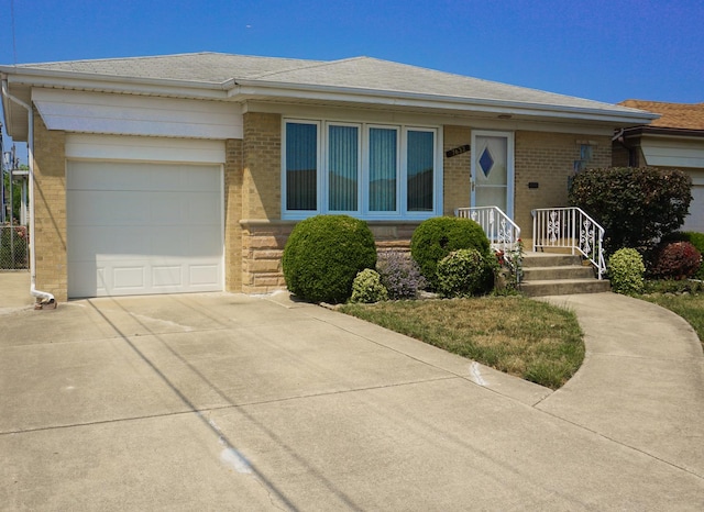 7632 W Norridge St, Harwood Heights, IL 60706 - view of front facade featuring brick siding, driveway, and a garage
