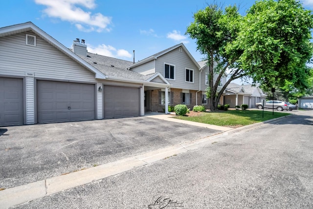 7000 Remington Ct Unit 102, Woodridge, IL 60517 - multi unit property with an attached garage, brick siding, a chimney, roof with shingles, and a front lawn