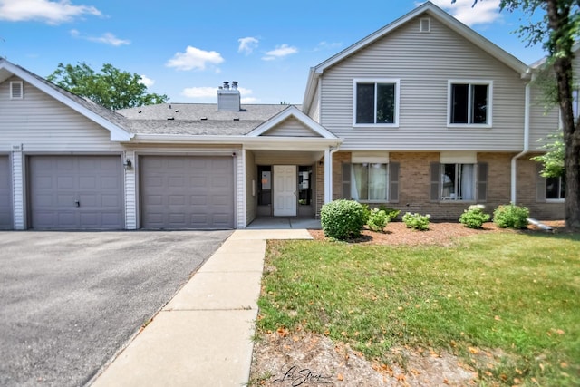 7000 Remington Ct Unit 102, Woodridge, IL 60517 - view of front of home with brick siding, a garage, driveway, a front lawn, and a chimney