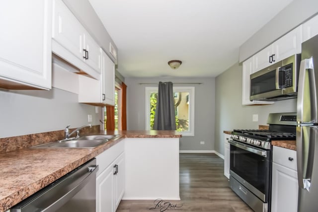 7000 Remington Ct Unit 102, Woodridge, IL 60517 - kitchen with stainless steel appliances, white cabinets, wood finished floors, and a peninsula