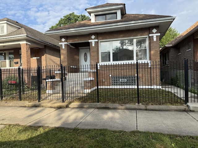 8014 S Bishop St, Chicago, IL 60620 - bungalow-style home featuring covered porch, brick siding, a fenced front yard, and a shingled roof