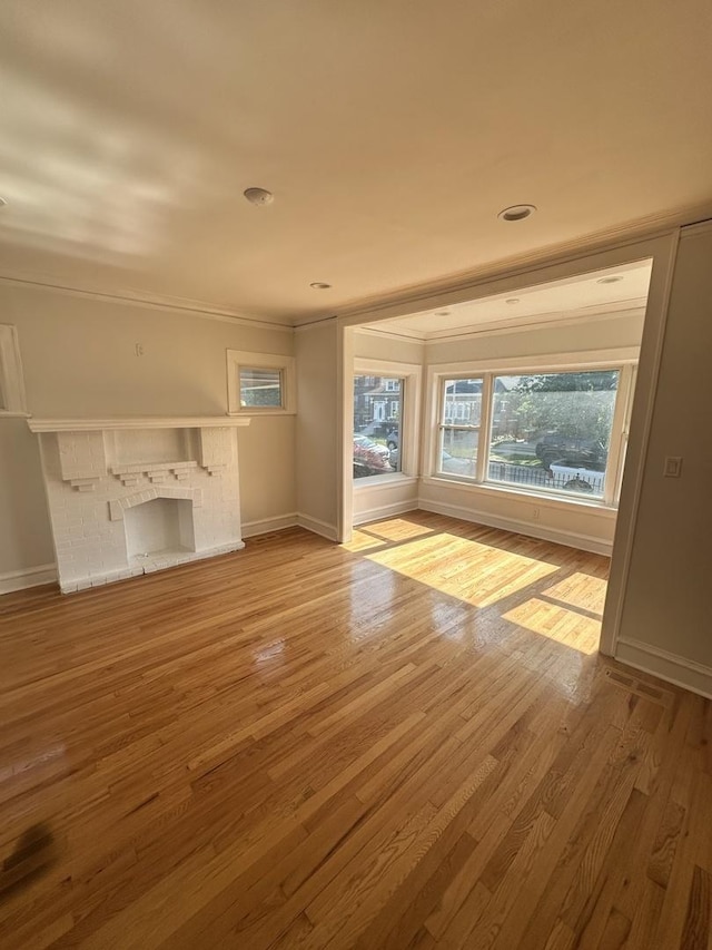 8014 S Bishop St, Chicago, IL 60620 - unfurnished living room with a fireplace, light wood-type flooring, and crown molding