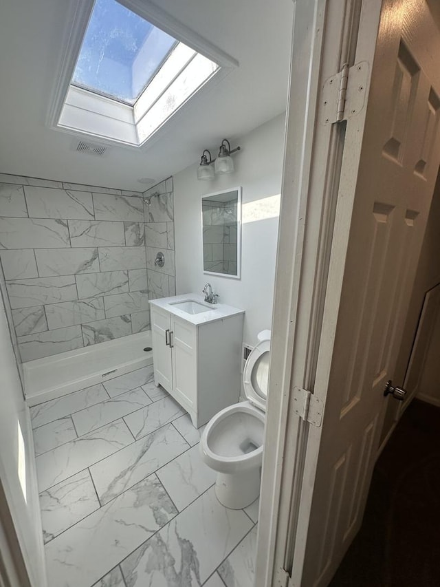 8014 S Bishop St, Chicago, IL 60620 - bathroom with marble finish flooring, a skylight, a stall shower, and vanity