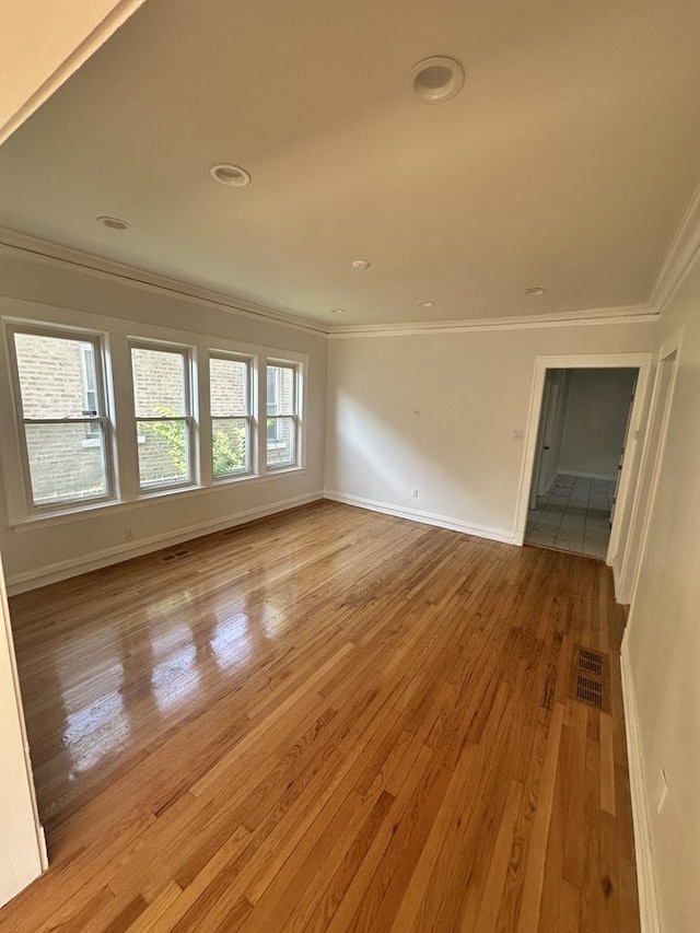 8014 S Bishop St, Chicago, IL 60620 - spare room with crown molding, light wood-style floors, and recessed lighting