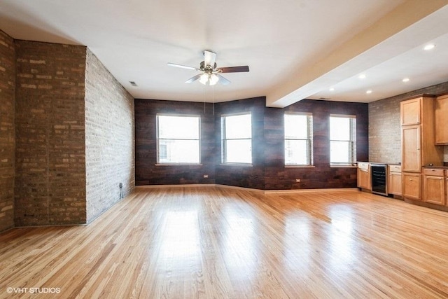 1634 W Columbia Ave Unit 2S, Chicago, IL 60626 - unfurnished living room featuring wine cooler, a ceiling fan, light wood-style floors, plenty of natural light, and beamed ceiling