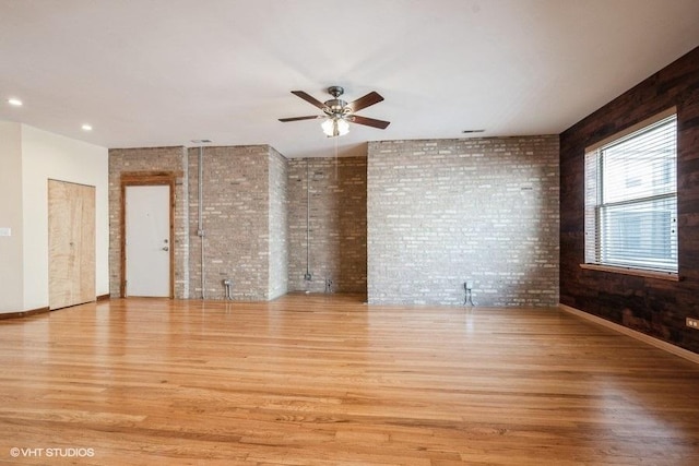 1634 W Columbia Ave Unit 2S, Chicago, IL 60626 - unfurnished room with wood finished floors, brick wall, and a ceiling fan