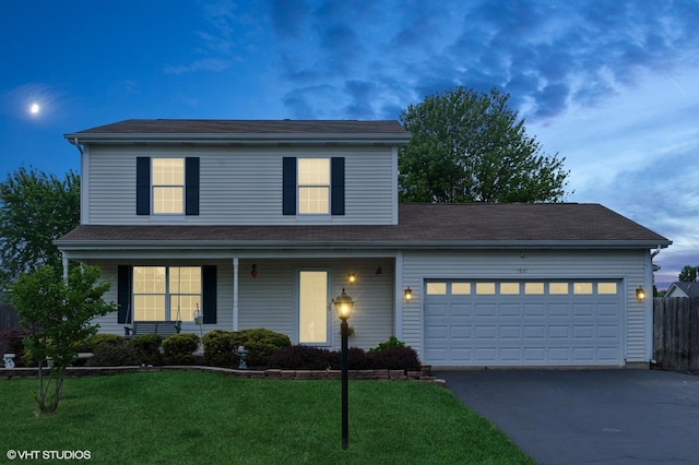 1531 Southport Ct, Zion, IL 60099 - traditional-style home featuring asphalt driveway, an attached garage, and a porch