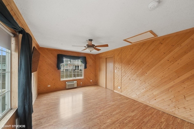1531 Southport Ct, Zion, IL 60099 - empty room featuring wooden walls, plenty of natural light, wood finished floors, attic access, and a textured ceiling