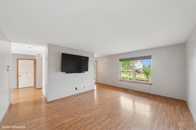 1531 Southport Ct, Zion, IL 60099 - unfurnished living room with light wood-type flooring and baseboards