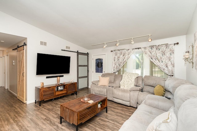 2308 Maple Ln, Rolling Meadows, IL 60008 - living area with a barn door, wood finished floors, vaulted ceiling, and track lighting