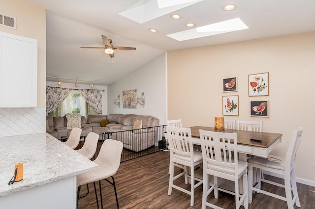 2308 Maple Ln, Rolling Meadows, IL 60008 - dining area with dark wood-type flooring, a skylight, lofted ceiling, and recessed lighting