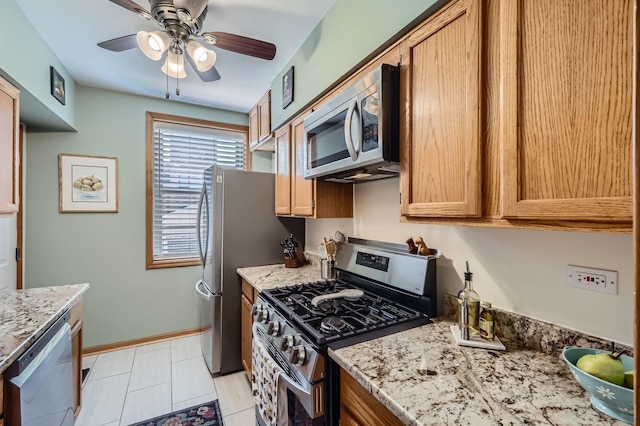 28 S 6th Ave Unit 1D, La Grange, IL 60525 - kitchen with appliances with stainless steel finishes, a ceiling fan, light stone countertops, and brown cabinets