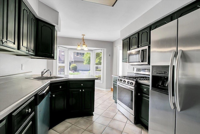 1921 Wisteria Ct Unit 3, Naperville, IL 60565 - kitchen with appliances with stainless steel finishes, light tile patterned flooring, a chandelier, pendant lighting, and dark cabinetry