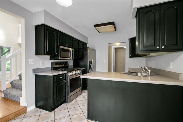1921 Wisteria Ct Unit 3, Naperville, IL 60565 - kitchen with stainless steel appliances, light tile patterned flooring, a peninsula, and light countertops