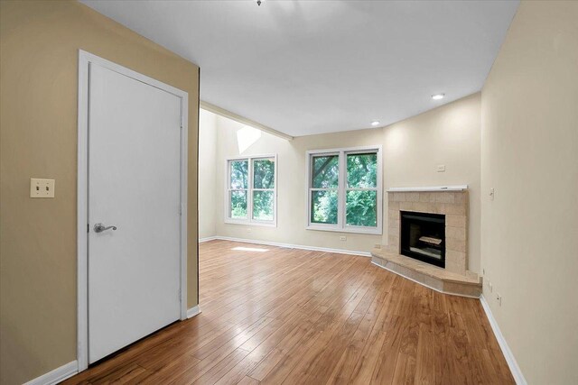 1921 Wisteria Ct Unit 3, Naperville, IL 60565 - unfurnished living room with hardwood / wood-style floors and a fireplace with raised hearth