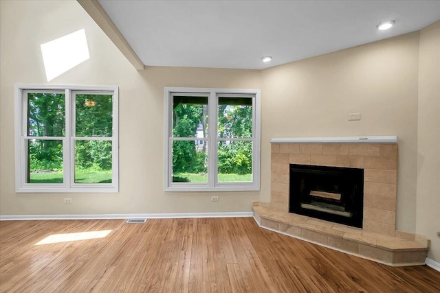 1921 Wisteria Ct Unit 3, Naperville, IL 60565 - unfurnished living room featuring wood finished floors and a tiled fireplace