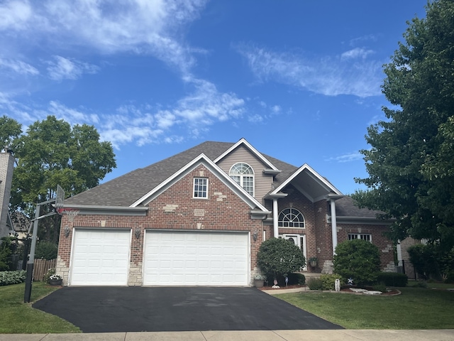 12534 Lily Ln, Plainfield, IL 60585 - traditional-style house featuring asphalt driveway, brick siding, a front yard, and a shingled roof