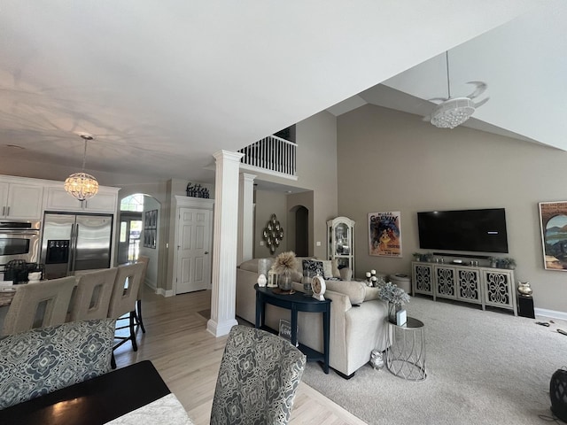 12534 Lily Ln, Plainfield, IL 60585 - living area featuring arched walkways, ornate columns, light wood-type flooring, and a high ceiling