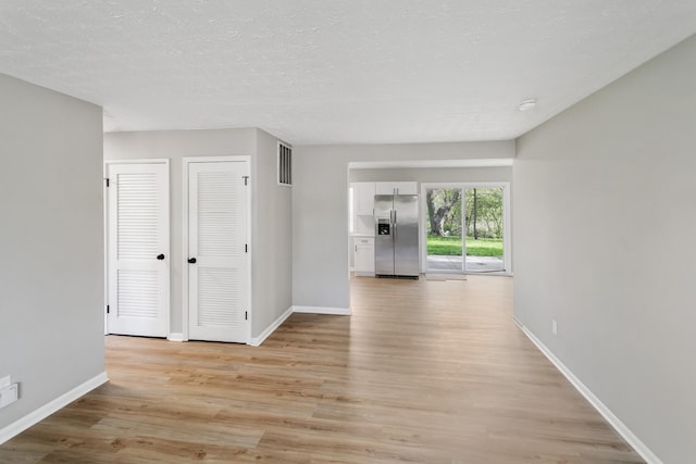 505 Barbara Ct, University Park, IL 60484 - unfurnished room with light wood-type flooring and a textured ceiling