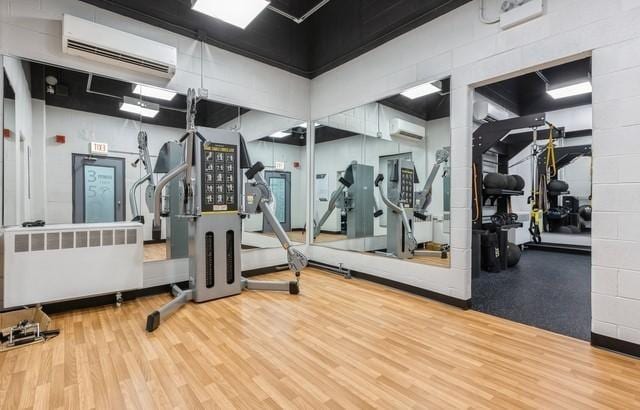 3550 N Lake Shore Dr Unit 1921, Chicago, IL 60657 - gym with a wall mounted AC, wood finished floors, and a wall mounted air conditioner