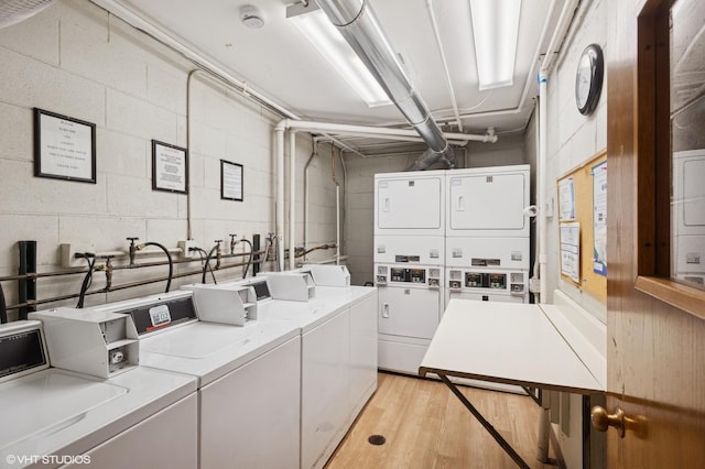 7200 N Ridge Blvd Unit 2C, Chicago, IL 60645 - community laundry featuring stacked washer and clothes dryer, concrete block wall, washer and dryer, and light wood-type flooring