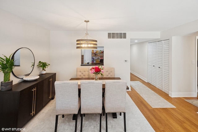 7200 N Ridge Blvd Unit 2C, Chicago, IL 60645 - dining area featuring light wood-style floors and baseboards