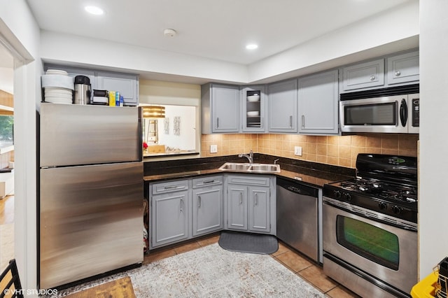 7200 N Ridge Blvd Unit 2C, Chicago, IL 60645 - kitchen featuring stainless steel appliances, gray cabinetry, dark countertops, tasteful backsplash, and recessed lighting