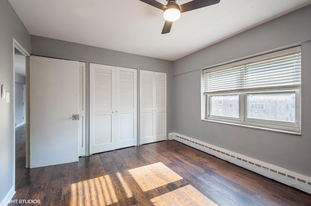 4960 N Marine Dr Unit 519, Chicago, IL 60640 - unfurnished bedroom featuring a baseboard heating unit, two closets, wood finished floors, and ceiling fan