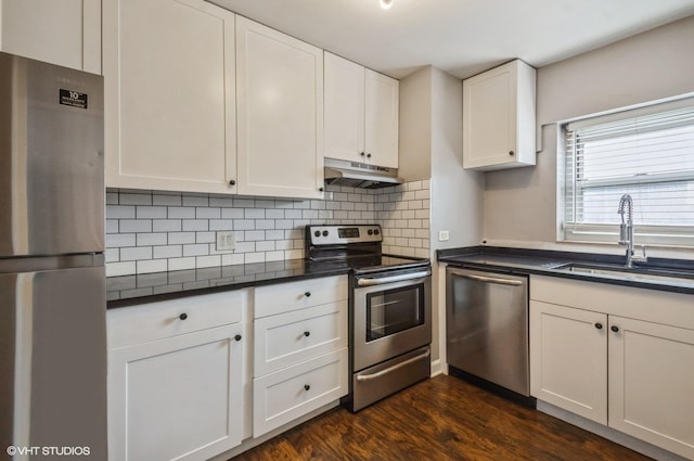 4960 N Marine Dr Unit 519, Chicago, IL 60640 - kitchen with appliances with stainless steel finishes, under cabinet range hood, dark countertops, white cabinets, and backsplash