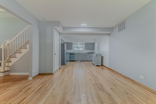 922 E Pratt Dr, Palatine, IL 60074 - unfurnished living room featuring light wood-style floors and stairway