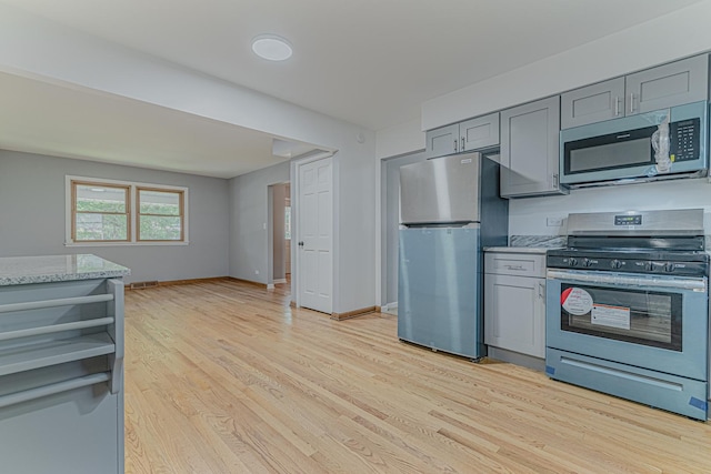 922 E Pratt Dr, Palatine, IL 60074 - kitchen featuring stainless steel appliances, gray cabinets, light wood finished floors, light stone countertops, and open shelves