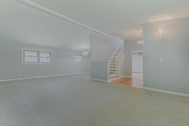 922 E Pratt Dr, Palatine, IL 60074 - unfurnished living room with stairs and light carpet