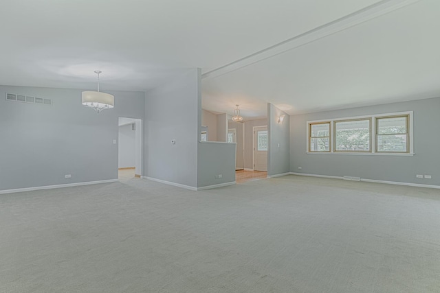 922 E Pratt Dr, Palatine, IL 60074 - empty room featuring vaulted ceiling, light colored carpet, and a chandelier