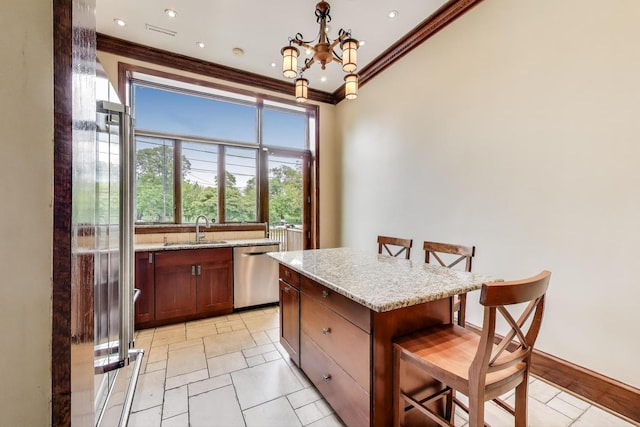 3215 S Calumet Ave, Chicago, IL 60616 - kitchen with stainless steel dishwasher, a breakfast bar area, ornamental molding, a chandelier, and decorative light fixtures