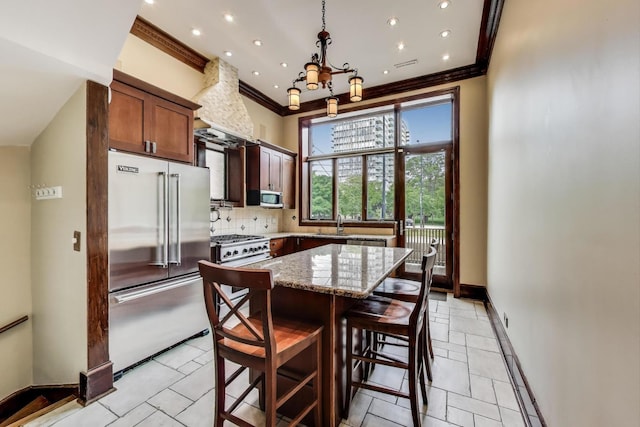 3215 S Calumet Ave, Chicago, IL 60616 - kitchen with high end appliances, crown molding, light stone counters, backsplash, and a chandelier
