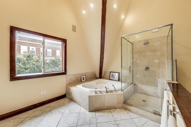 3215 S Calumet Ave, Chicago, IL 60616 - bathroom featuring marble look tile flooring, a bath, a shower stall, and vaulted ceiling
