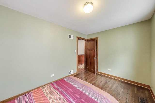 3215 S Calumet Ave, Chicago, IL 60616 - unfurnished bedroom with baseboards and wood finished floors