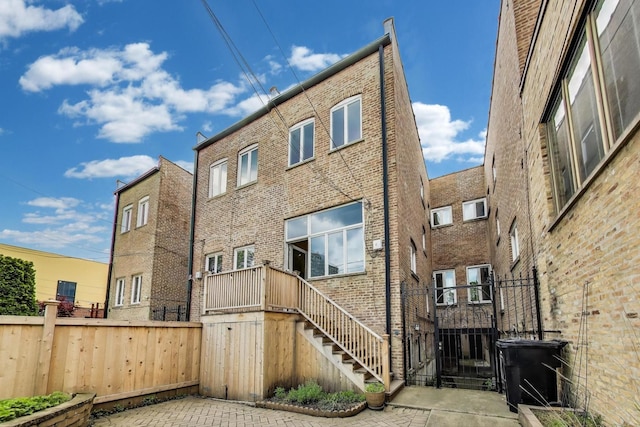 3215 S Calumet Ave, Chicago, IL 60616 - rear view of house featuring brick siding and stairs