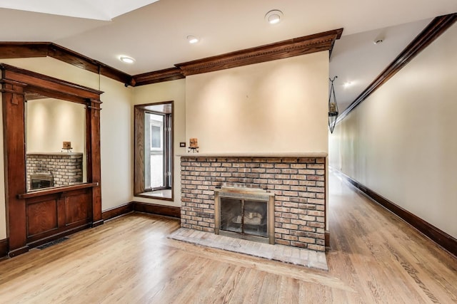 3215 S Calumet Ave, Chicago, IL 60616 - unfurnished living room with a brick fireplace, crown molding, wood finished floors, and vaulted ceiling