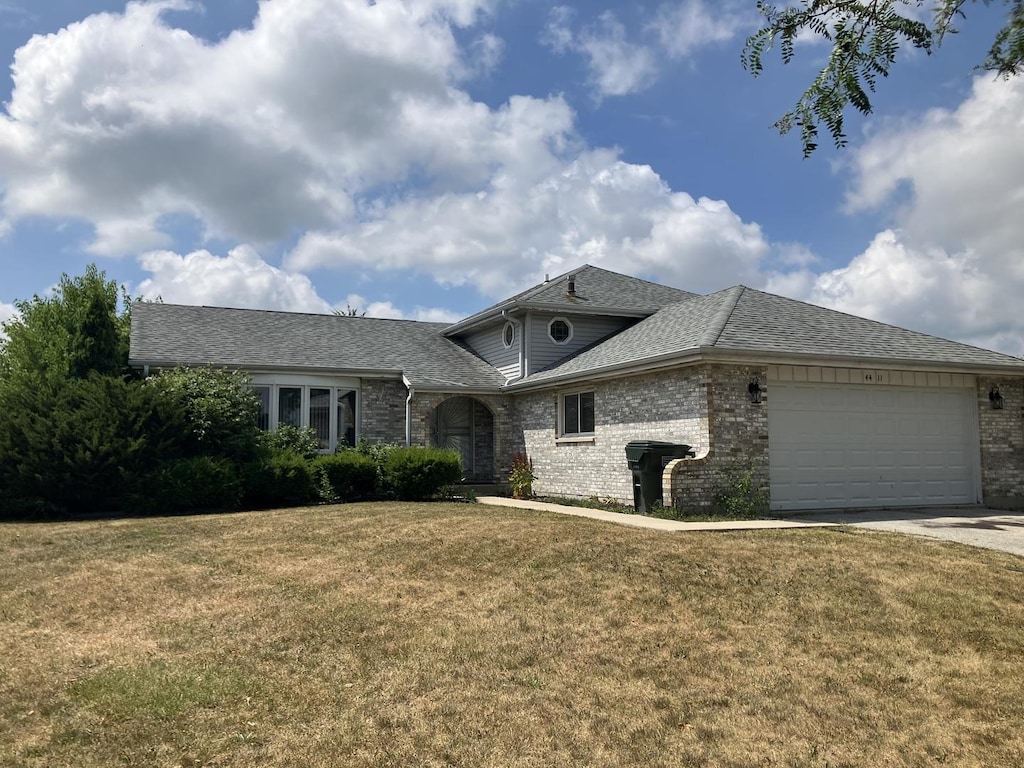 4411 Michael John Ct, Richton Park, IL 60471 - view of front facade with an attached garage, driveway, a front lawn, and brick siding