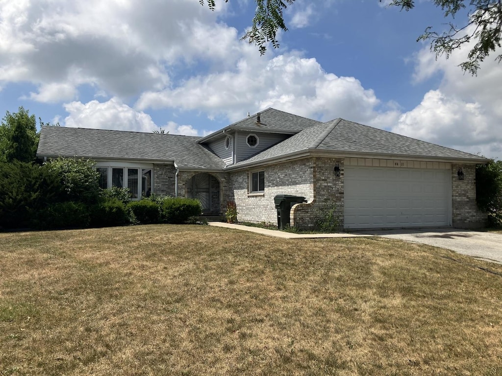 4411 Michael John Ct, Richton Park, IL 60471 - view of front of home with brick siding, concrete driveway, a garage, and a front lawn