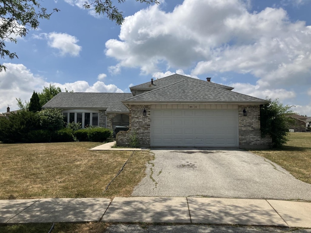 4411 Michael John Ct, Richton Park, IL 60471 - view of front of house featuring driveway, brick siding, a front lawn, and an attached garage