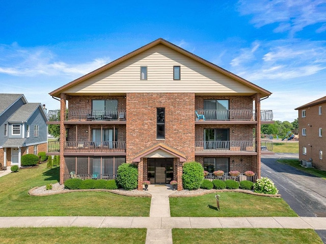 16719 Paxton Ave Unit 2S, Tinley Park, IL 60477 - view of front of home featuring a balcony, brick siding, and a front lawn