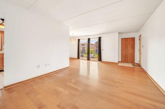 16719 Paxton Ave Unit 2S, Tinley Park, IL 60477 - empty room featuring light wood-style floors and a chandelier